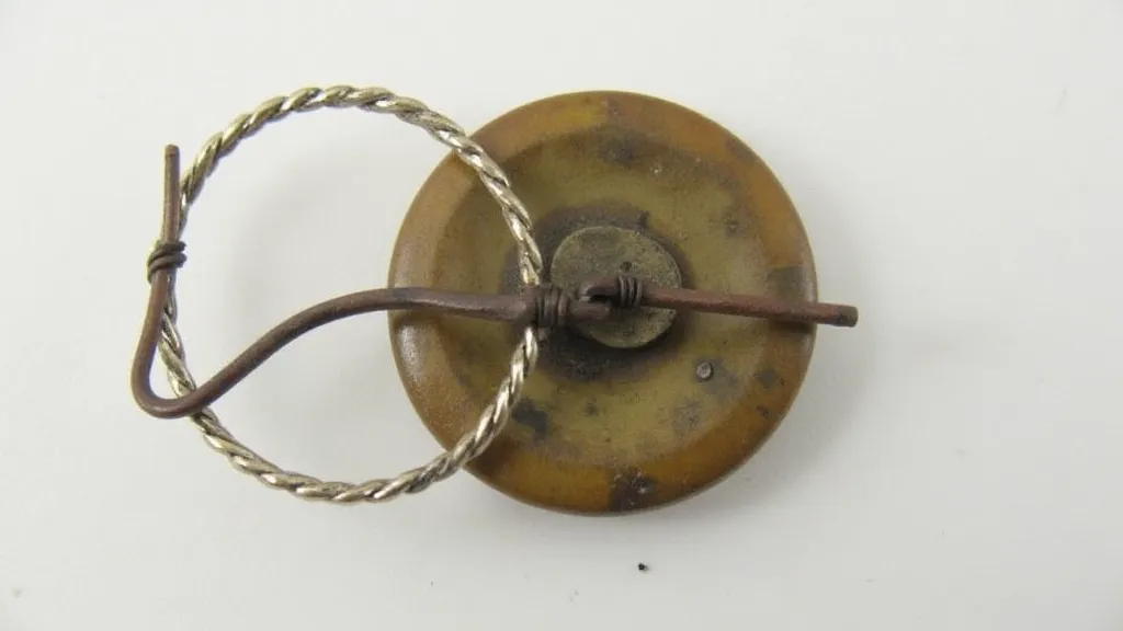 Antique button with a wire clasp